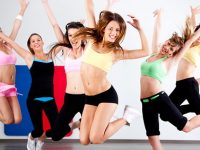 Enthusiastic group of women having fun during aerobics class.